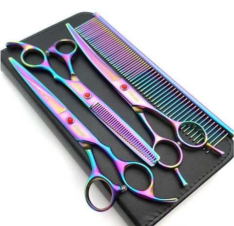 Set of colorful pet grooming scissors and comb on a black tray