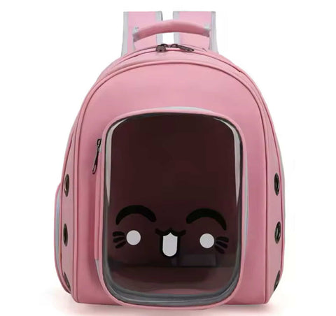 Pink pet carrier with a cute face design on a white background