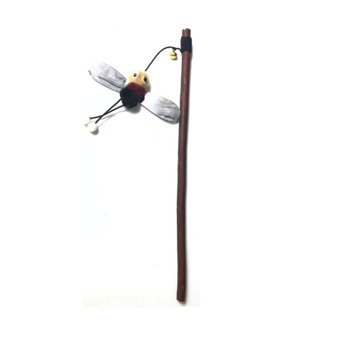 Dragonfly-shaped toy on a stick against a white background