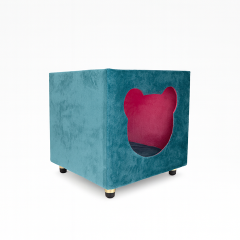 Teal pet bed with a pink interior on a white background