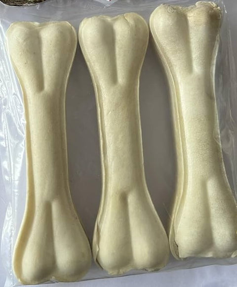 Three rawhide dog bones on a clear plastic background