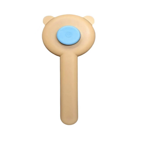 Toy with a bear-like design and blue button on a white background