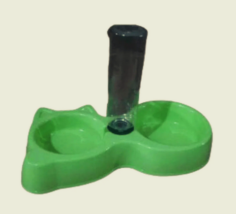 Green plastic object with a black cylindrical component on a beige background