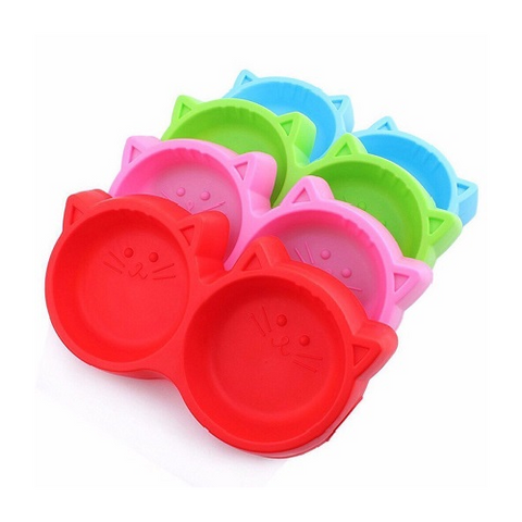 Set of colorful silicone pet bowls with cat face design on a white background
