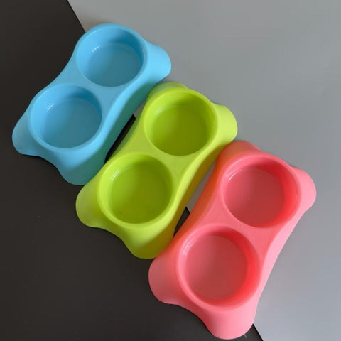 Three colorful silicone snack cups on a black and white surface