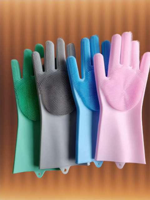 Set of colorful gloves with silicone scrubbers on a wooden surface