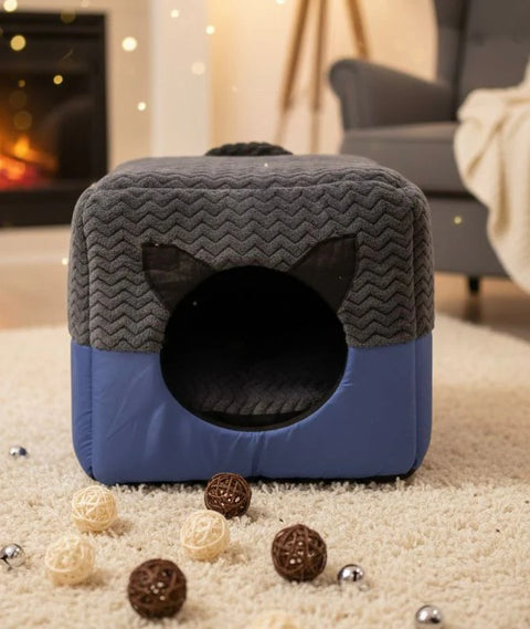 Gray and blue pet bed with cat inside in a cozy living room setting.