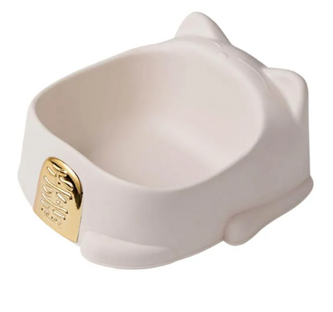 White ceramic dog bowl with gold emblem on a white background