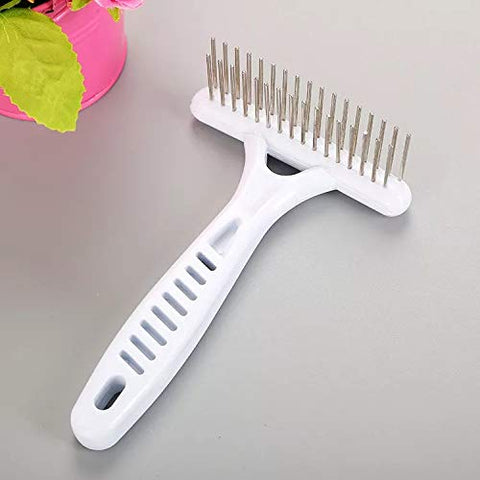 White pet grooming brush with metal pins on a gray surface