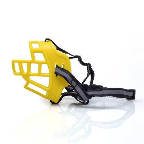Yellow dog muzzle with black straps on a white background