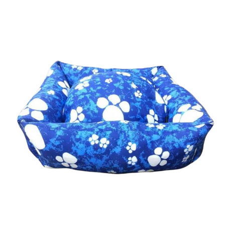 Blue pet bed with white paw prints on a white background