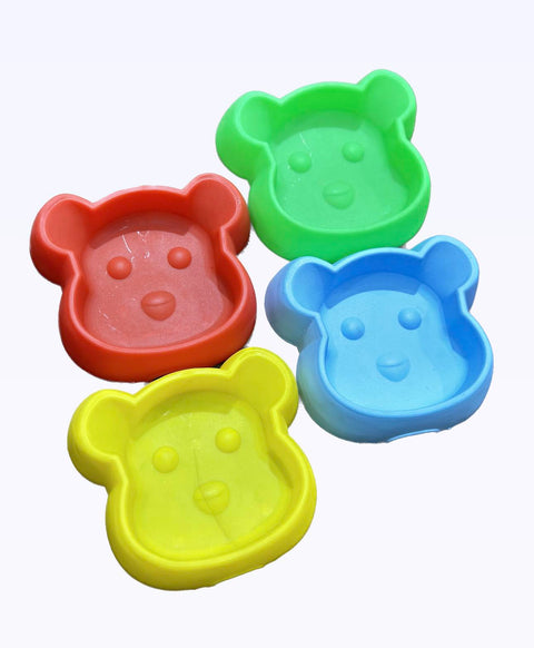 Four colorful bear-shaped molds on a white background