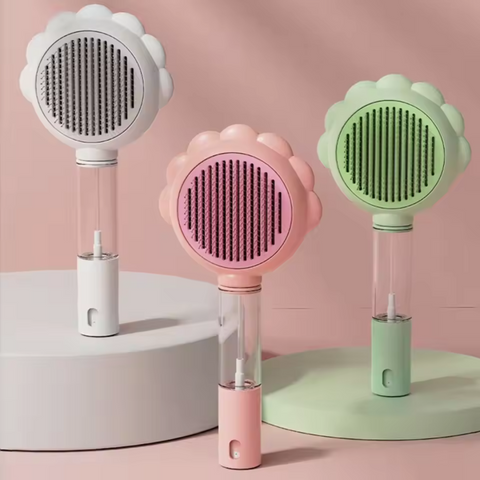 Three handheld cleaning brushes in white, pink, and green on a pink background