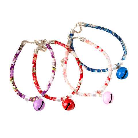 Set of colorful cat collars with bells on a white background