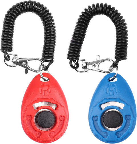 Two dog training clickers, one red and one blue, with coiled black leashes on a white background.