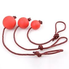 Three red balls on a string with a knot against a white background