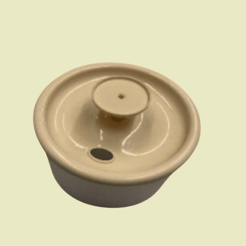 Beige ceramic pot with lid on a beige background