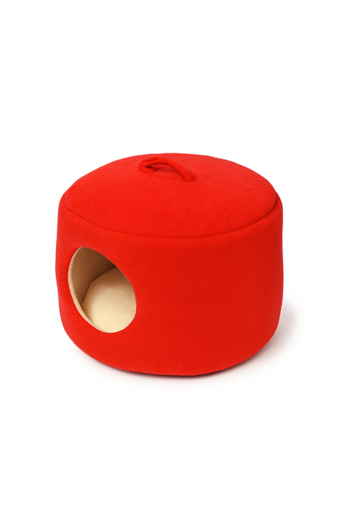 Red cat house with a circular entrance on a white background