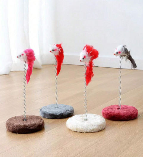 Four cat toys with feathered mice on stands on a wooden floor.