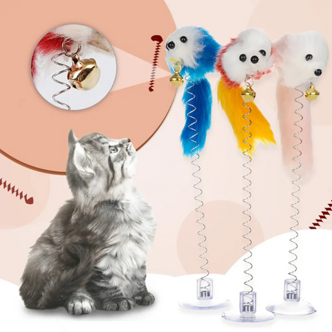 Cat playing with a toy, with colorful cat toys on a pink background